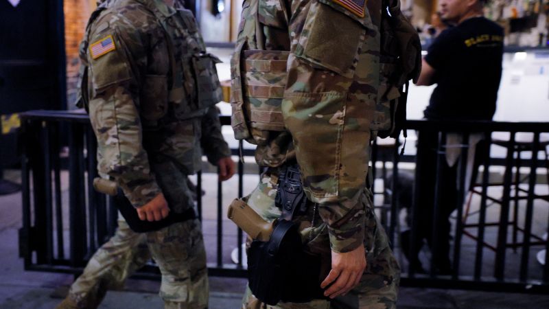 National Guard troops in Washington, DC, begin carrying weapons