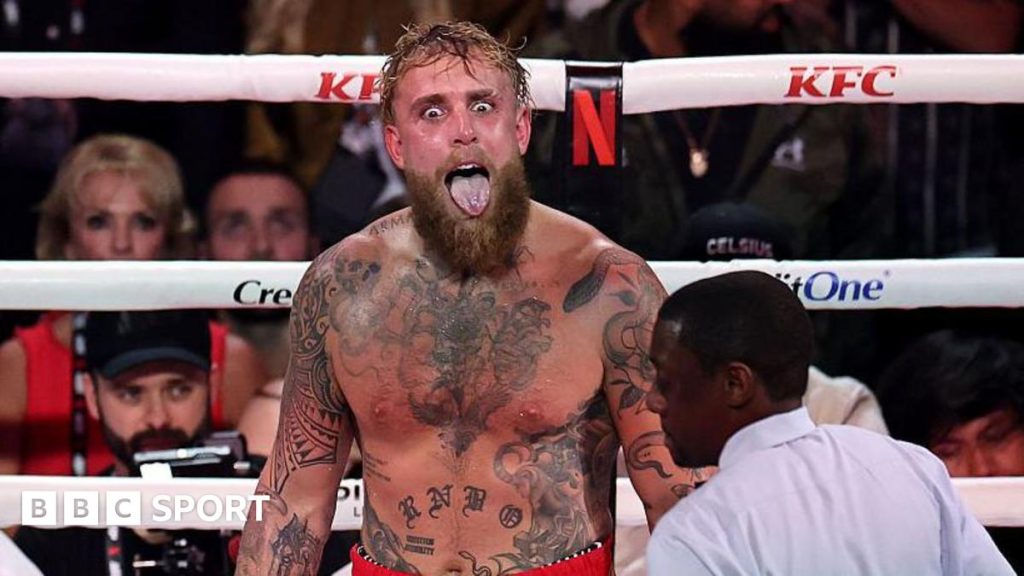 Jake Paul sticks his tongue out during a fight